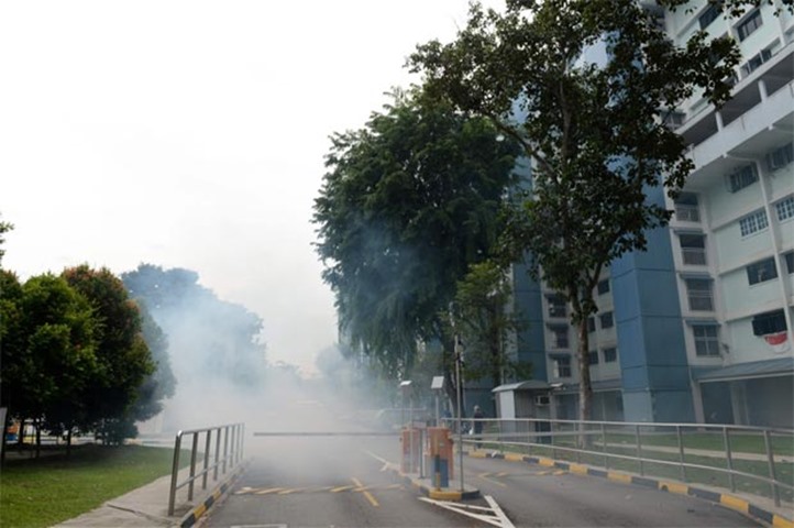 A cloud of smoke during mosquito fumigation is seen around a residential estate in Bedok North