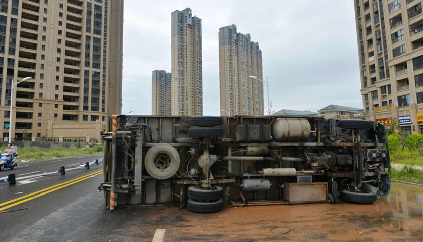 An overturned truck is seen on a street in Xiamen