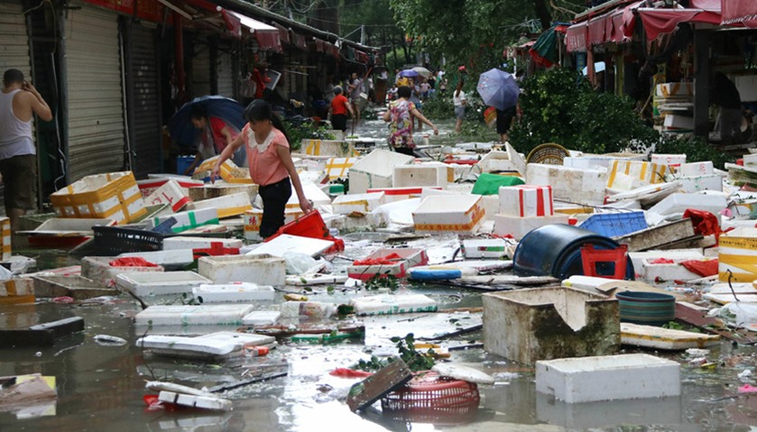 Residents clean up a flooded street in Xiamen, in China  after Typhoon Meranti