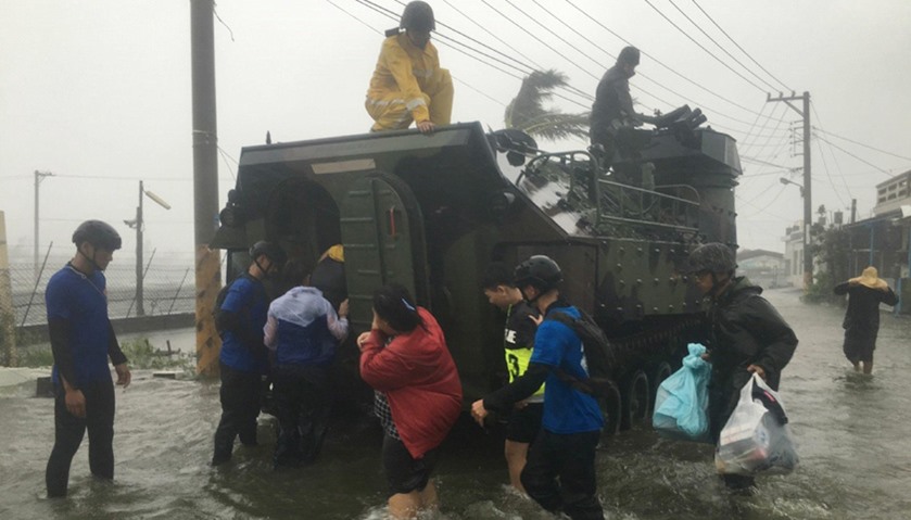 residents affected by super typhoon Meranti being evacuated on a military armoured vehicle