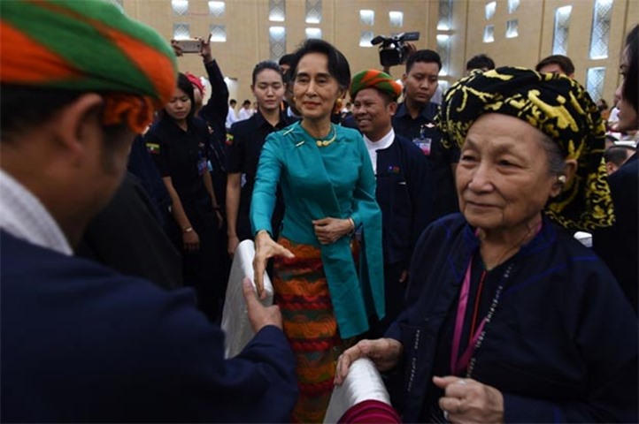 Myanmar State Counsellor Aung San Suu Kyi greets delegates during a peace conference reception