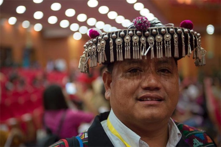 A peace conference delegate from Akha ethnic group wears traditional costume with silver ornaments