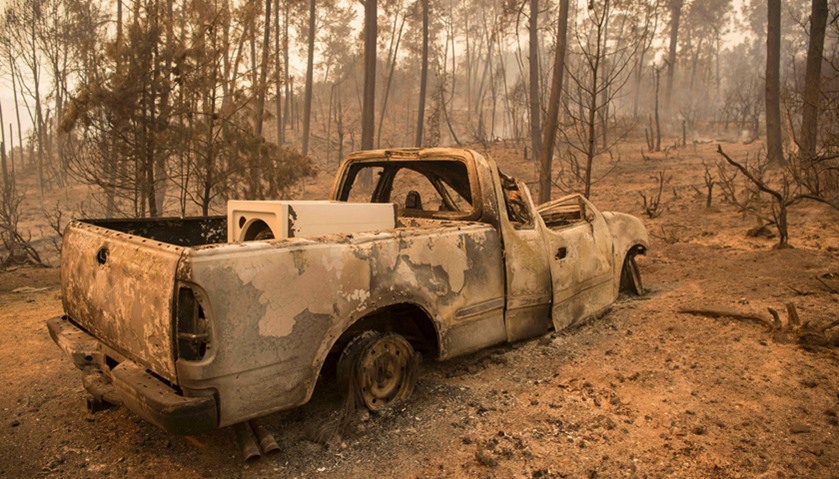 A burned out truck is seen at a property in the Santa Cruz Mountains