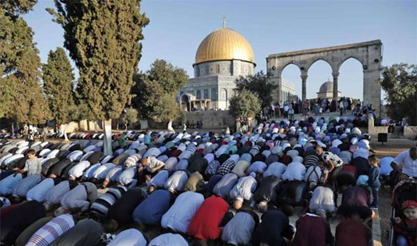 Palestinians pray on the first day of Eid al-Adha near the Dome of Rock inside the Al-Aqsa compound
