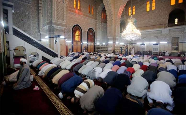 Iraqis attend Eid prayers at a mosque in Baghdad on Friday