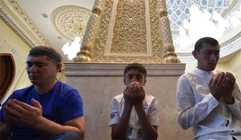 Kyrgyz Muslims pray at a mosque on the first day of Eid al-Adha in Bishkek on Friday