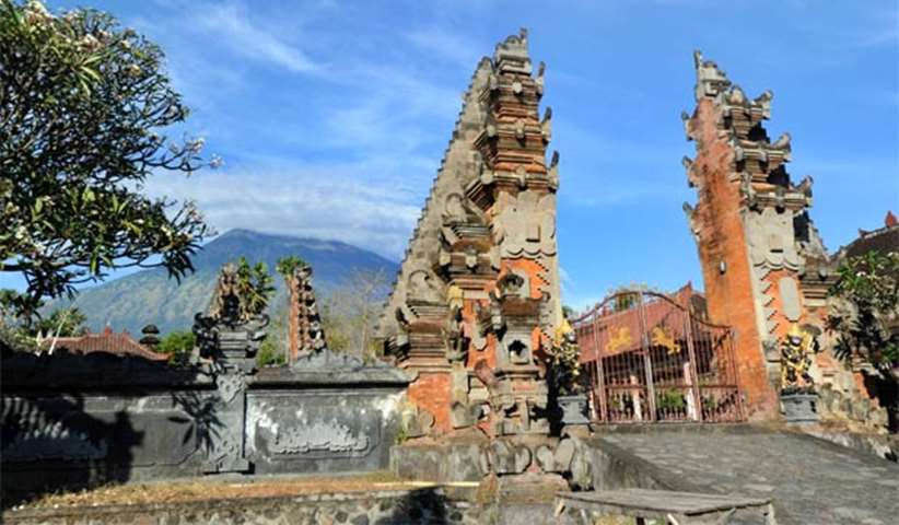 Mount Agung volcano is looming in the background of a Balinese Hindu temple
