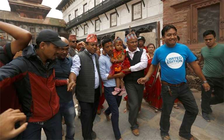 Trishna Shakya is being taken towards the Kumari House at Hanumandhoka Durbar Square in Kathmandu