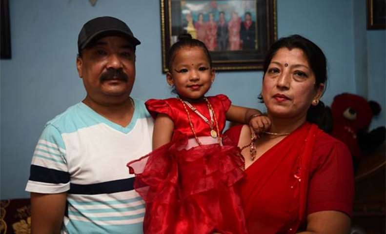 Trishna Shakya poses with her grandparents as she prepares to be the new Kumari