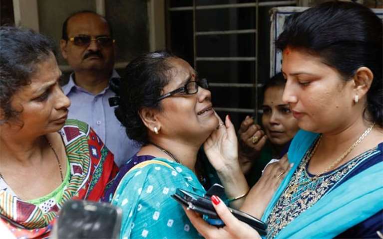 A relative of a stampede victim grieves at a hospital in Mumbai