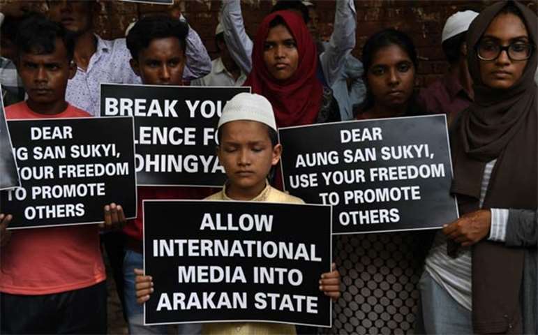 Rohingya refugees along with Indian supporters hold placards during a protest in New Delhi