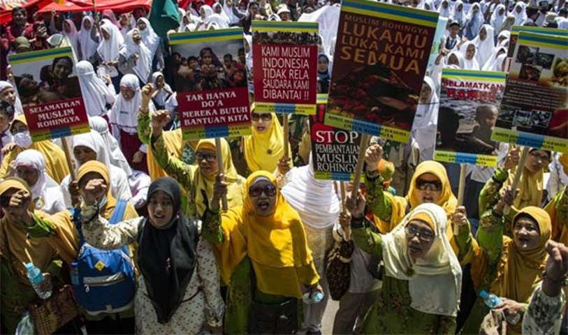 Indonesian activists hold placards during a rally in Surabaya on the humanitarian crisis in Rakhine 
