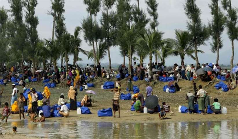 Rohingya refugees from Rakhine state rest near Ukhia, on the border between Bangladesh and Myanmar