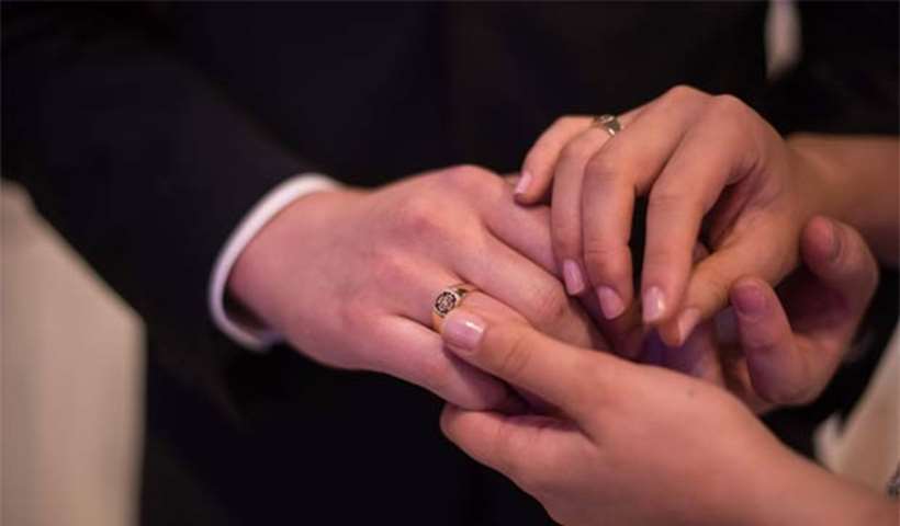 A couple hold hands during the \'cosmic blessing ceremony\', in Gapyeong on Thursday