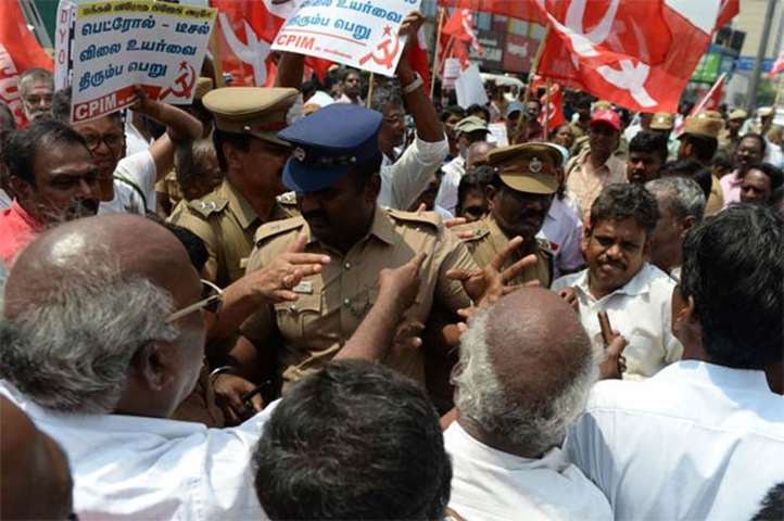 Police scuffle with activists of CPI-M during a protest against fuel hike in Chennai on Monday