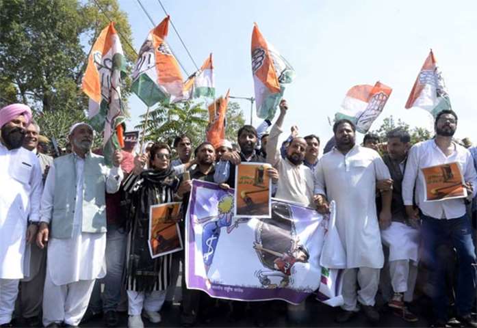 Activists of Congress party shout anti-government slogans during a protest in Srinagar on Monday