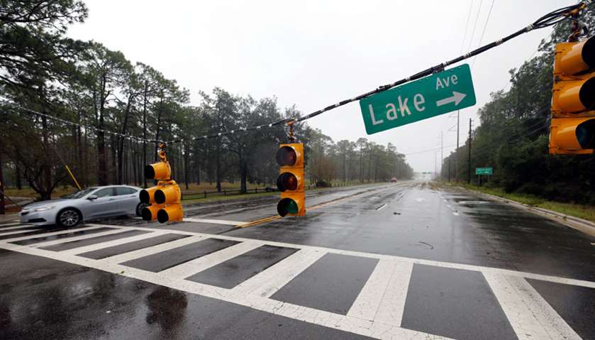 A motorist drives past fallen traffic lights after the arrival of Hurricane Florence