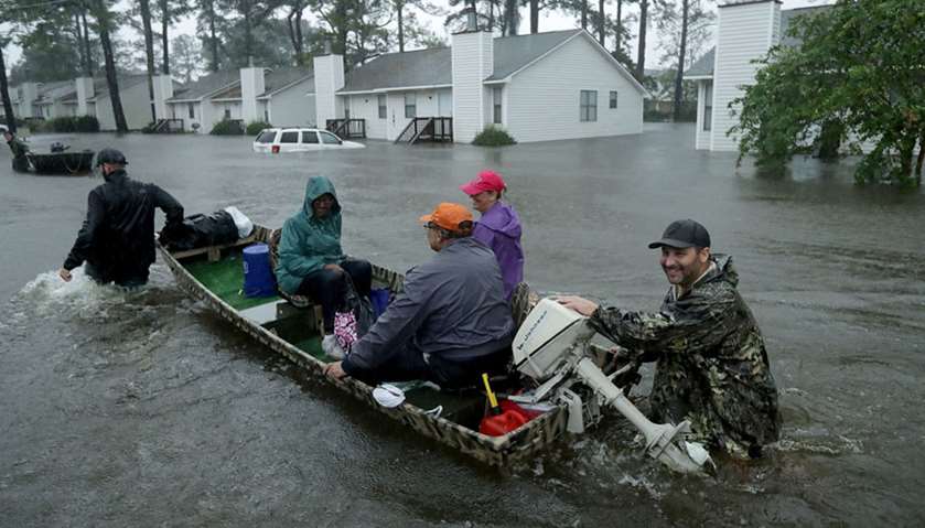 Volunteers from all over North Carolina help rescue residents and their pets from their flooded home