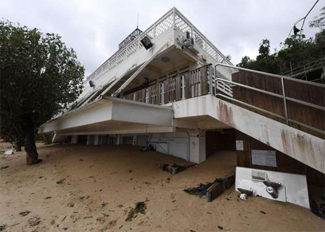 The ground floor of a clubhouse is buried in sand at Deep Water Bay in Hong Kong on Monday