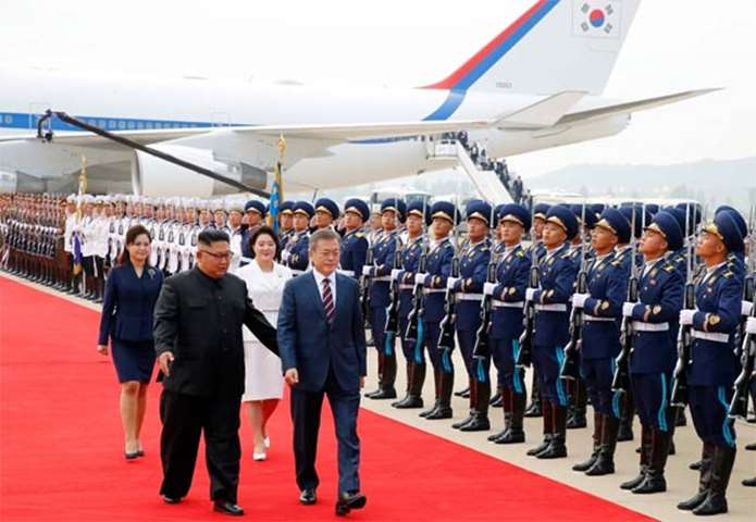 Kim Jong Un and Moon Jae-in review honour guards during a welcoming ceremony on Tuesday