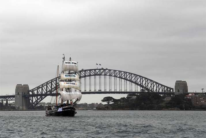 The ship Southern Swan sails in front of Sydney\'s Harbour Bridge with environmentalists on board