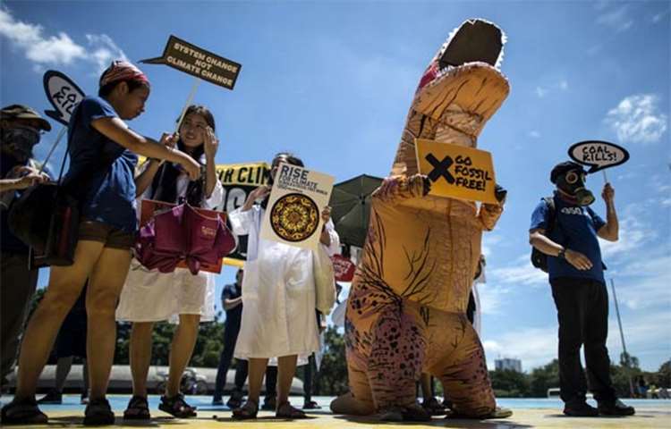 Protesters displaying placards march during a demonstration in Manila on Saturday