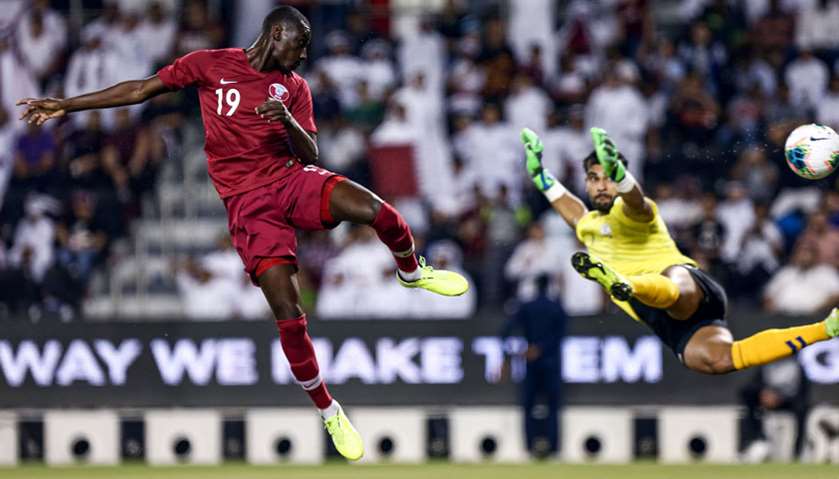 Qatar\'s forward Almoez Ali scores a goal during the second round Group E qualification football