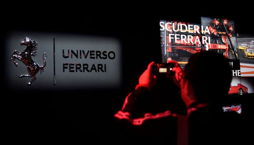 A visitor takes photos during the \'Universo Ferrari\' exhibition, in Maranello, Italy