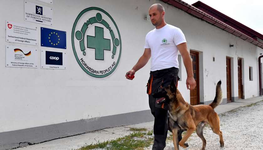 A dog trainer walks with a dog at training facility near Sarajevo