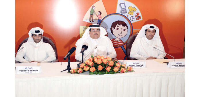 Yousef Darwish (centre), CSR head Yousef Fakhroo (left), and AGM public relations Sultan al-Naimi during the launch of the book. PICTURE: Thajudheen