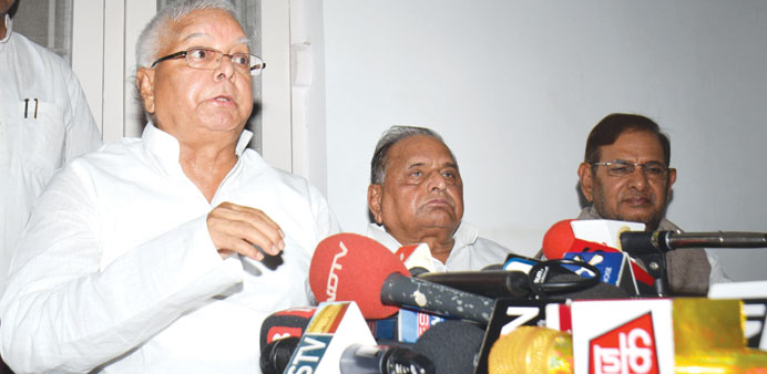 RJD chief Lalu Prasad Yadav speaks to reporters after a meeting in New Delhi yesterday as Samajwadi Party (SP) supremo Mulayam Singh Yadav looks on.