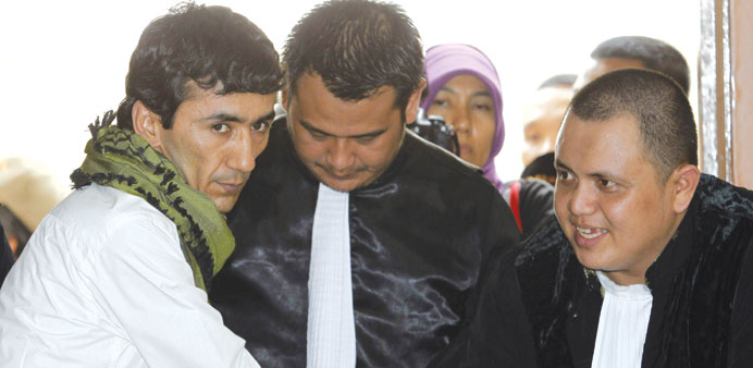 Sayed Abbas with his lawyers after his trial in Jakarta yesterday.
