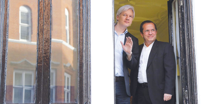 WikiLeaks founder Julian Assange waves with Ecuadoru2019s Foreign Affairs Minister Ricardo Patino at Ecuadoru2019s embassy in central London yesterday.