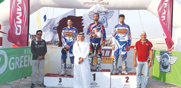 Mohamed al-Balooshi (centre), Saeed al-Shenqiti (second from right) and Moath al-Ansari pose on the podium after the second E2 race yesterday.