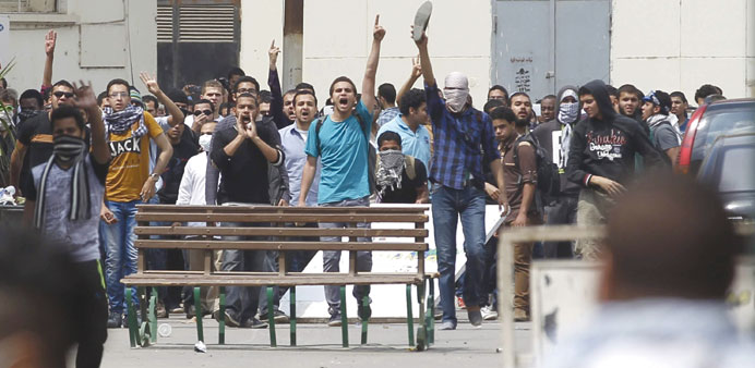 Students supporting the Muslim Brotherhood demonstrate outside Cairo University yesterday.