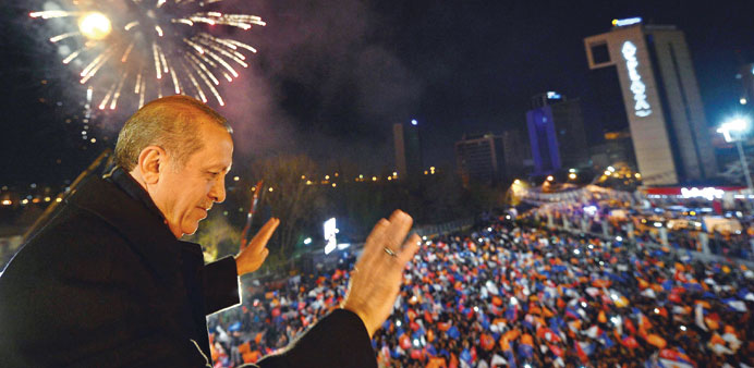 A March 30 handout picture released by the Prime Ministeru2019s Press Office shows Erdogan acknowledging his supporters in Ankara.