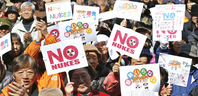Anti-nuclear protesters hold banners during a march in Tokyo yesterday, ahead of the third anniversary of an earthquake and tsunami that triggered the