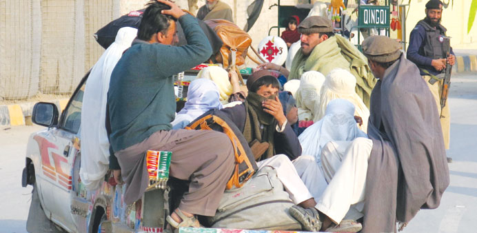Families sit in the back of a vehicle as they flee a military offensive against the Pakistani Taliban and enter Bannu yesterday.