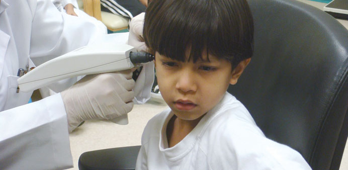 A child being examined during a hearing check up.