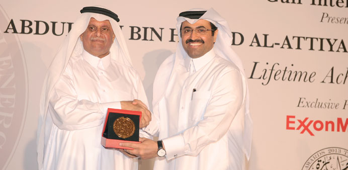 HE Abdullah bin Hamad al-Attiyah hands over the u201cLifetime achievement for the advancement of the Qatari energy industryu201d award to HE the Minister of E