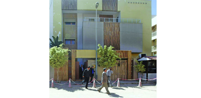 Embassy staff walk in front of the Jordanian embassy in Tripoli yesterday. 