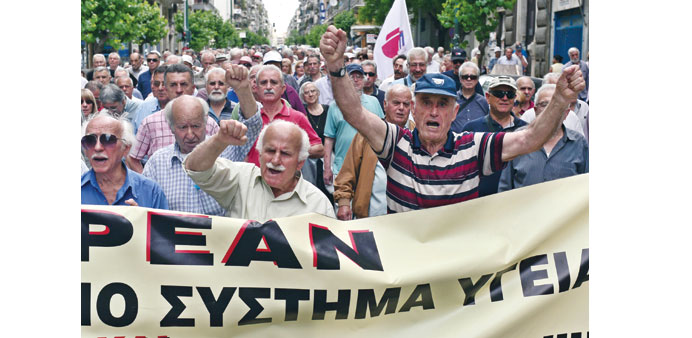  Pensioners march yesterday towards the Ministry of Health in Athens during a 24-hour strike by health workers and doctors.