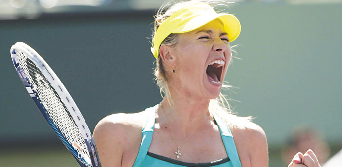 Maria Sharapova of Russia celebrates during her victory over Sara Errani of Italy in their quarter-final match at the Sony Open tennis tournament in K