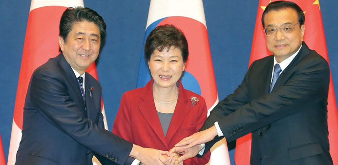 South Korean President Park Geun-hye, Japanese Prime Minister Shinzo Abe and Chinese premier Li Keqiang at the summit in Seoul yesterday.
