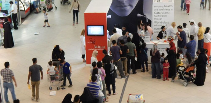 Visitors line up for a health check at the booth.
