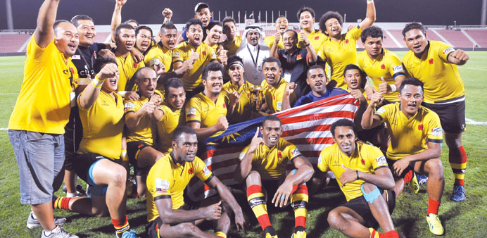 Malaysian players celebrate their win over Qatar in the Asian5Nations rugby tournament yesterday.
