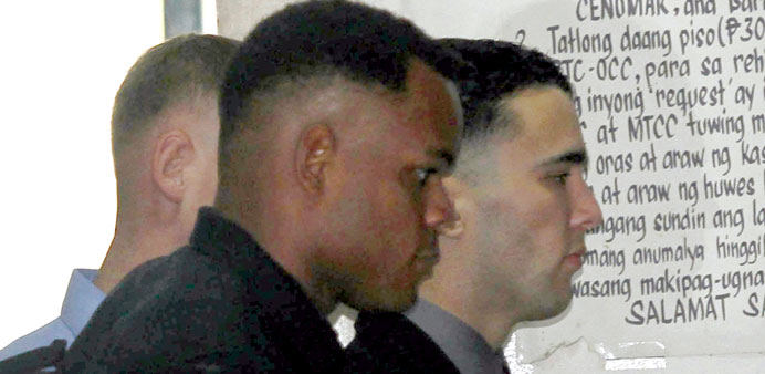 US Marine Joseph Scott Pemberton (right) is escorted by US soldiers as he attends a court hearing in Olongapo yesterday.