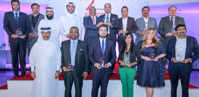 Ezdan Mall officials seen with recipients of the u201cRetail Excellence Awards 2014.u201d