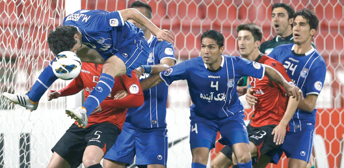  Nathan (5) of Qataru2019s Al-Rayyan fights for the ball with Mojtaba Jabari (L) of Iranu2019s Esteghlal during their AFC Champions League soccer match at the