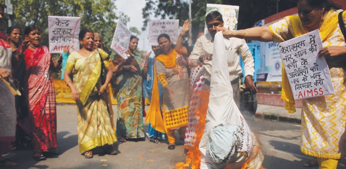 Activists of the All India Mahila Samskrutika Sangha (AIMSS) burn an effigy during a protest against the rape of a four-year-old, in New Delhi yesterd